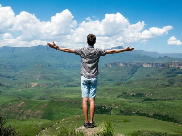 man wearing grey shirt standing on elevated surface